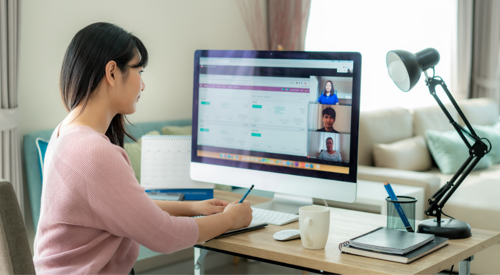Young woman sitting at computer monitor